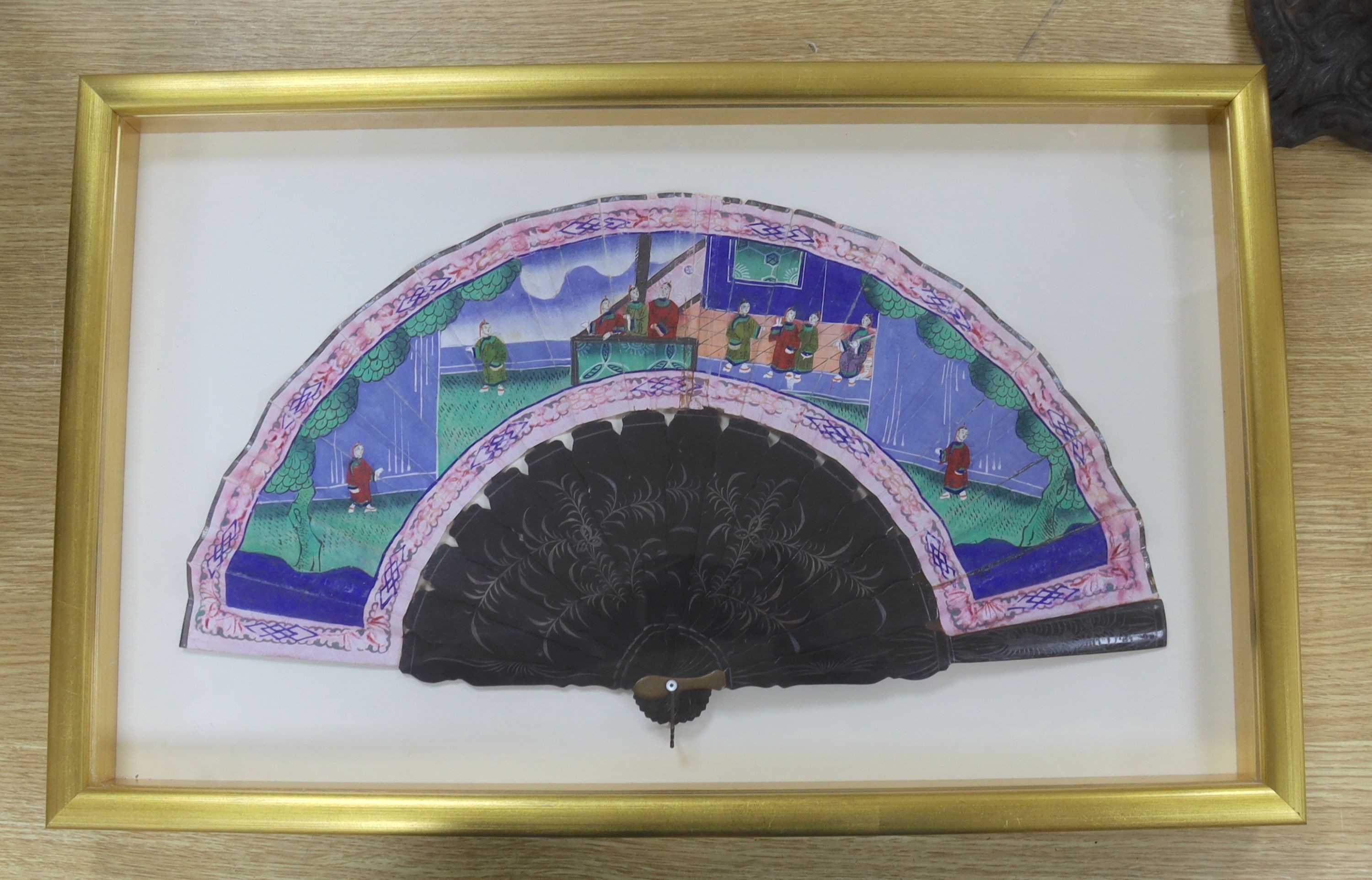 Two Chinese export painted leaf fans, 19th century, one with carved sandalwood guards and sticks, the other with black lacquer, largest case 39 x 63cm